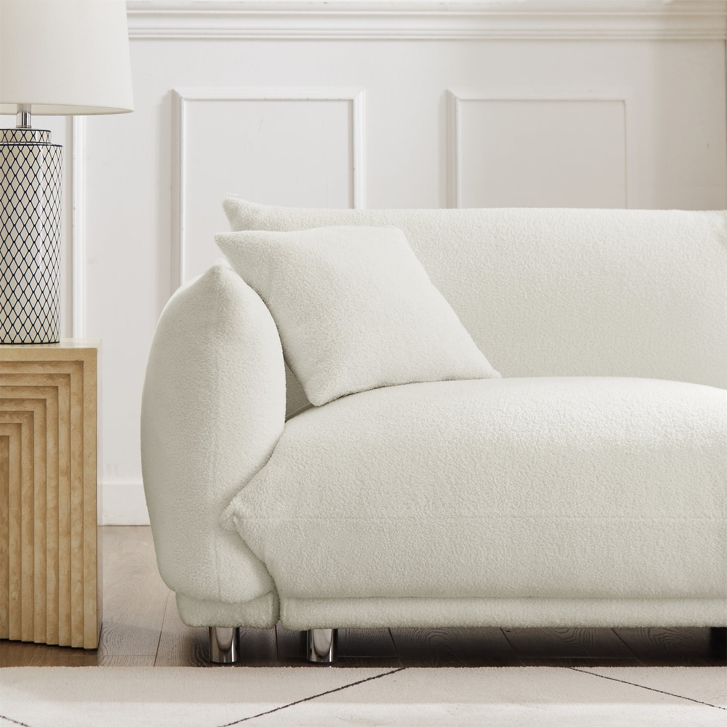 A lovable, fat, bread-like sofa with 2 pillows and metal feet with anti-skid pads